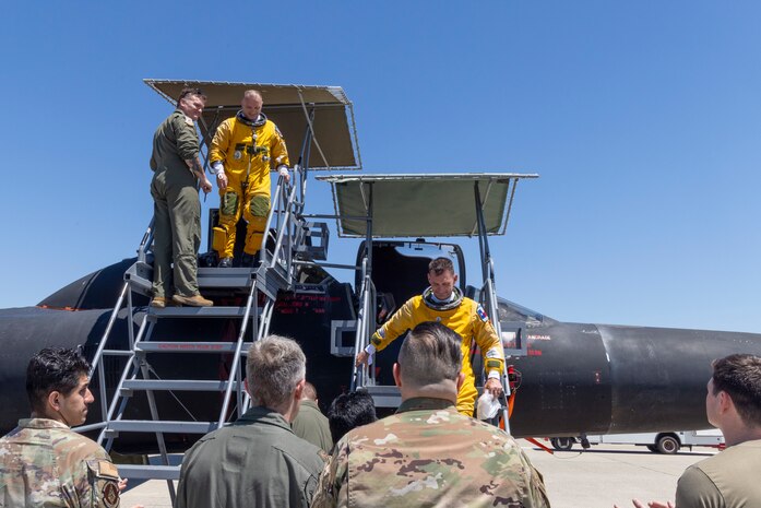 Cory “ULTRALORD” Bartholomew, 1st Reconnaissance Squadron (RS) assigned flight safety officer and U-2 instructor pilot, and Lt. Col. “JETHRO”, 1st RS instructor pilot and U-2 chief pilot, are greeted by members of the 9th Reconnaissance Wing, after landing a TU-2S Dragon Lady at Beale Air Force Base (AFB), California, Aug. 1st, 2025.