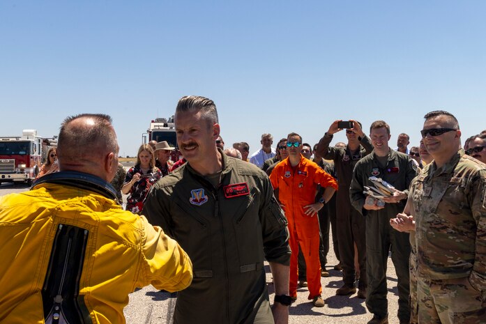 U.S. Air Force Col. Keagan McLeese, 9th Reconnaissance Wing commander, coins Cory “ULTRALORD” Bartholomew, 1st Reconnaissance Squadron (RS) assigned flight safety officer, after also coining Lt. Col. “JETHRO”, 1st RS instructor pilot and U-2 chief pilot, after they landed a 9th Reconnaissance Wing TU-2S Dragon Lady at Beale Air Force Base (AFB), California, July 31st, 2025.