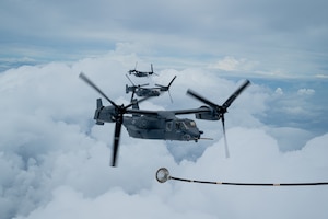 Three CV-22 Ospreys fly in formation in preparation for aerial refuel.