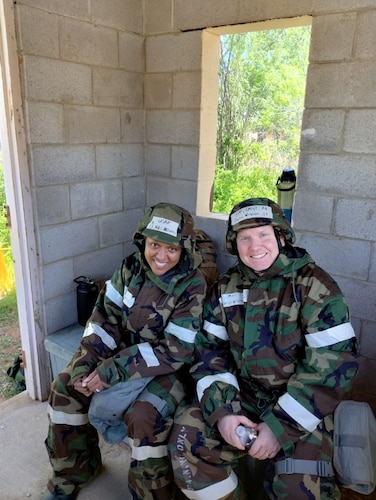two people pose for photo in military uniform