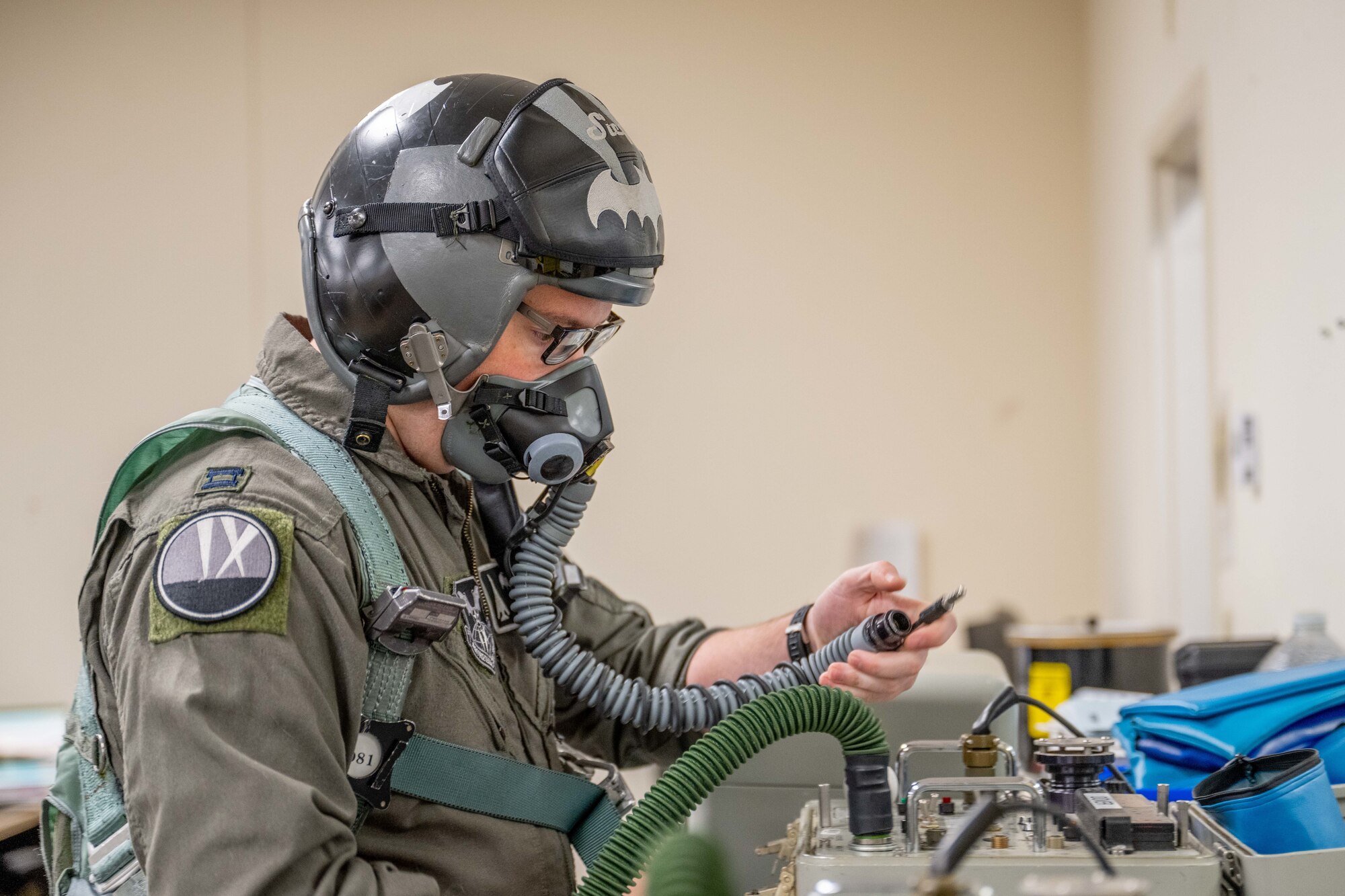 U.S. Air Force Capt. Ryan Gorski, 9th Bomb Squadron pilot, puts on flight equipment in preparation for a mission in support of Red Flag-Nellis 25-3 at Dyess Air Force Base, Texas, July 25, 2025. Red Flag 25-3 gave Dyess aviators the opportunity to fly both as “Blue Air” and “Red Air,” alternating between friendly strike roles and simulated adversary missions. (U.S. Air Force photo by Airman Caleb Schellenberg)