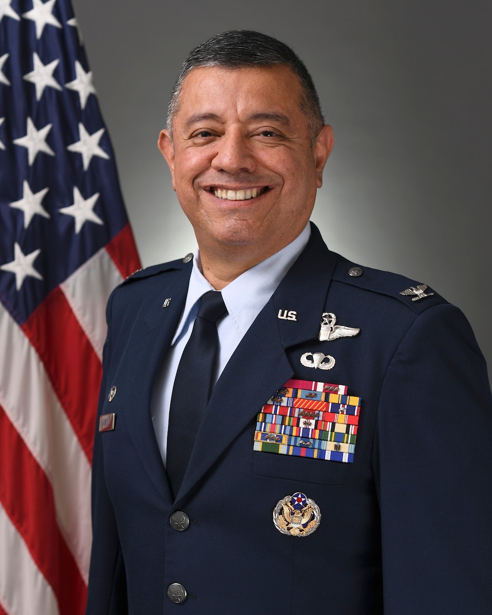 An official U.S. Air Force photo of Col. Abel Ramos in front of the American flag