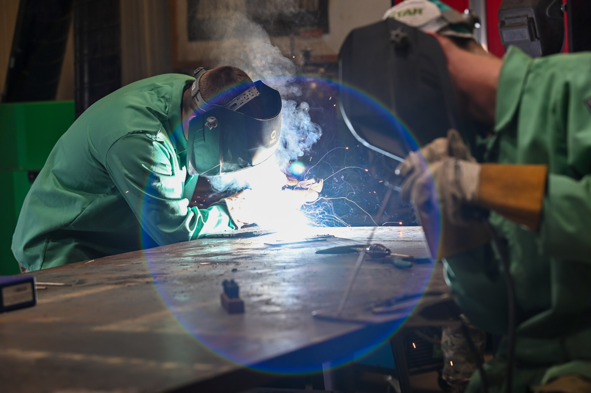 Airman 1st Class Caleb Norton and Senior Airman Kyle Perkins, each structures apprentices from the 155th Civil Engineering Squadron, practice shielded metal arc welding, a skill necessary to complete upgrade training, June 18, 2025, at the 119th Regional Training Site, in Fargo, North Dakota.
