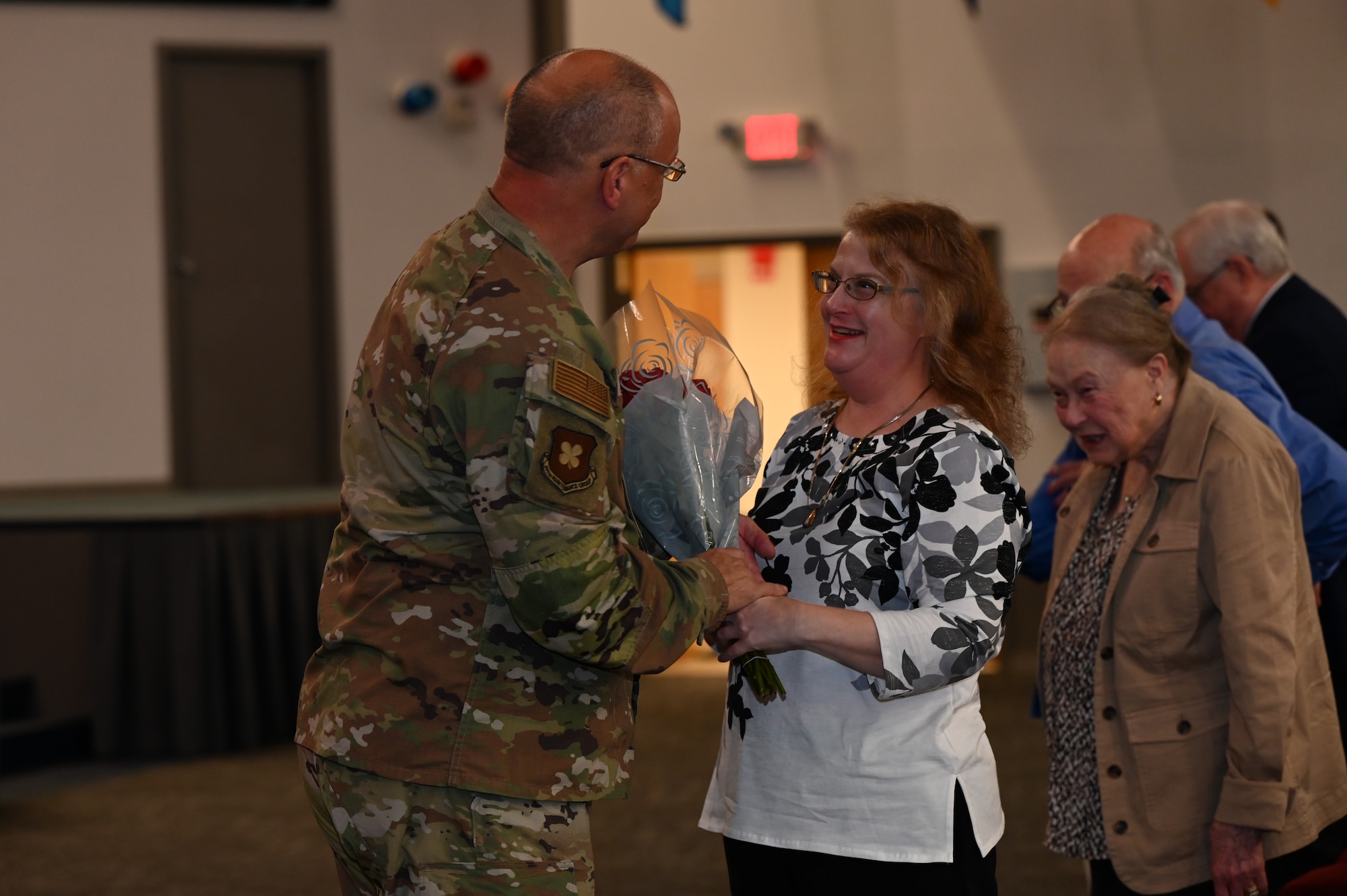 Airman gives flowers to his wife.