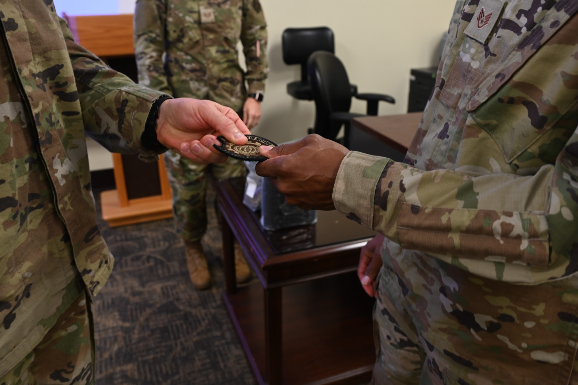 403rd Logistics Readiness Squadron commander hands out the new patches to the squadron members.
