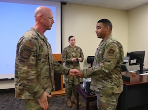 Logistics Readiness Squadron commander hands out the new patches to the squadron members.