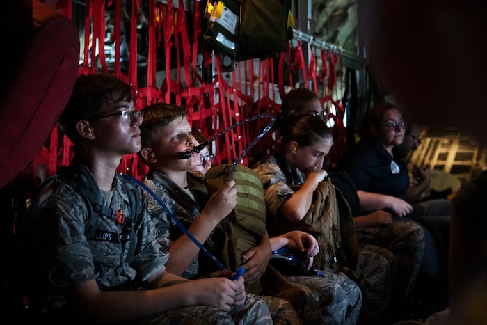 Civil Air Patrol cadets look out the window during a flight.