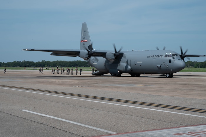 Civil Air Patrol cadets walk in to the back of a C-130J.