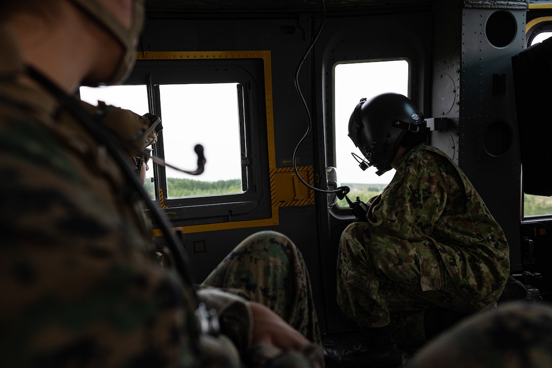 A Japanese Self-Defense Force service member and U.S. Navy hospital corpsmen travel in a UH-1 helicopter during a medical evacuation drill in support of Artillery Relocation Training Program 25.1 at the Kushiro City General Hospital, Hokkaido, Japan, June 6, 2025. ARTP, established by the 1997 Special Action Committee in Okinawa, relocates live-fire artillery training from Okinawa to mainland Japan to maintain readiness and stabilize U.S. Forces’ basing, enhancing regional security across Japan and the Indo-Pacific. This training boosts the capabilities and readiness of the Marine Corps’ only permanently forward-deployed artillery unit, enabling accurate indirect fire support. The U.S. Navy Sailors are with 3d Battalion, 12th Marines, 3d Marine Division. (U.S. Marine Corps photo by Cpl. Evelyn Doherty)