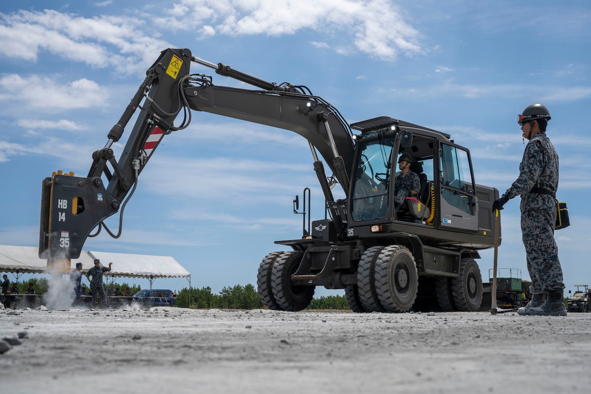 A Japan Air Self-Defense Force airman assigned to the 3rd Air Wing operates an excavator with impactor attachment during a rapid airfield damage repair exercise as a part of Resolute Force Pacific 2025 at Draughon Range near Misawa Air Base, Japan, July 29, 2025.