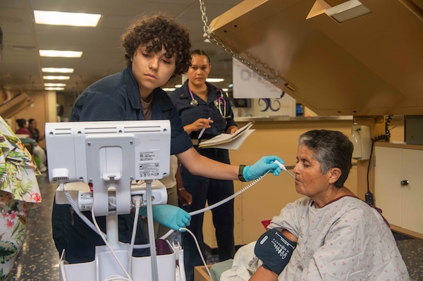 Hospitalman Selene Cruz, assigned to the Mercy-class hospital ship USNS Comfort (T-AH 20), checks the vitals of a Costa Rican patient aboard Comfort in Limón, Costa Rica during Continuing Promise 2025, July 28, 2025. Continuing Promise 2025 is the 16th iteration of the U.S. 4th Fleet/U.S. Naval Forces Southern Command-led mission since 2007 which aims to foster goodwill strengthen existing partnerships with partner nations and form new partnerships between host nations non-federal entities and international organizations.