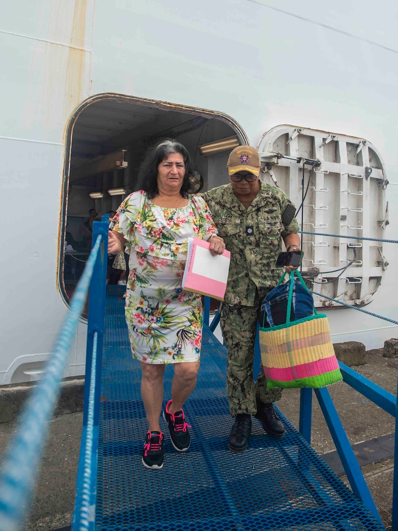 Cmdr. Liza Stone, assigned to the Mercy-class hospital ship USNS Comfort (T-AH 20), helps a patient depart Comfort in Limón, Costa Rica during Continuing Promise 2025, July 28, 2025. Continuing Promise 2025 is the 16th iteration of the U.S. 4th Fleet/U.S. Naval Forces Southern Command-led mission since 2007 which aims to foster goodwill strengthen existing partnerships with partner nations and form new partnerships between host nations non-federal entities and international organizations.