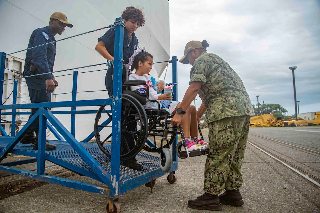 Sailors assigned to the Mercy-class hospital ship USNS Comfort (T-AH 20) assist a patient departing Comfort in Limón, Costa Rica during Continuing Promise 2025, July 28, 2025. Continuing Promise 2025 is the 16th iteration of the U.S. 4th Fleet/U.S. Naval Forces Southern Command-led mission since 2007 which aims to foster goodwill strengthen existing partnerships with partner nations and form new partnerships between host nations non-federal entities and international organizations.