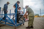 LIMÓN, Costa Rica (July 28, 2025) Sailors assigned to the Mercy-class hospital ship USNS Comfort (T-AH 20) assist a patient departing Comfort in Limón, Costa Rica during Continuing Promise 2025, July 28, 2025. Continuing Promise 2025 is the 16th iteration of the U.S. 4th Fleet/U.S. Naval Forces Southern Command-led mission since 2007 which aims to foster goodwill strengthen existing partnerships with partner nations and form new partnerships between host nations non-federal entities and international organizations. (U.S. Navy photo by Mass Communication Specialist 2nd Class Thomas Boatright)