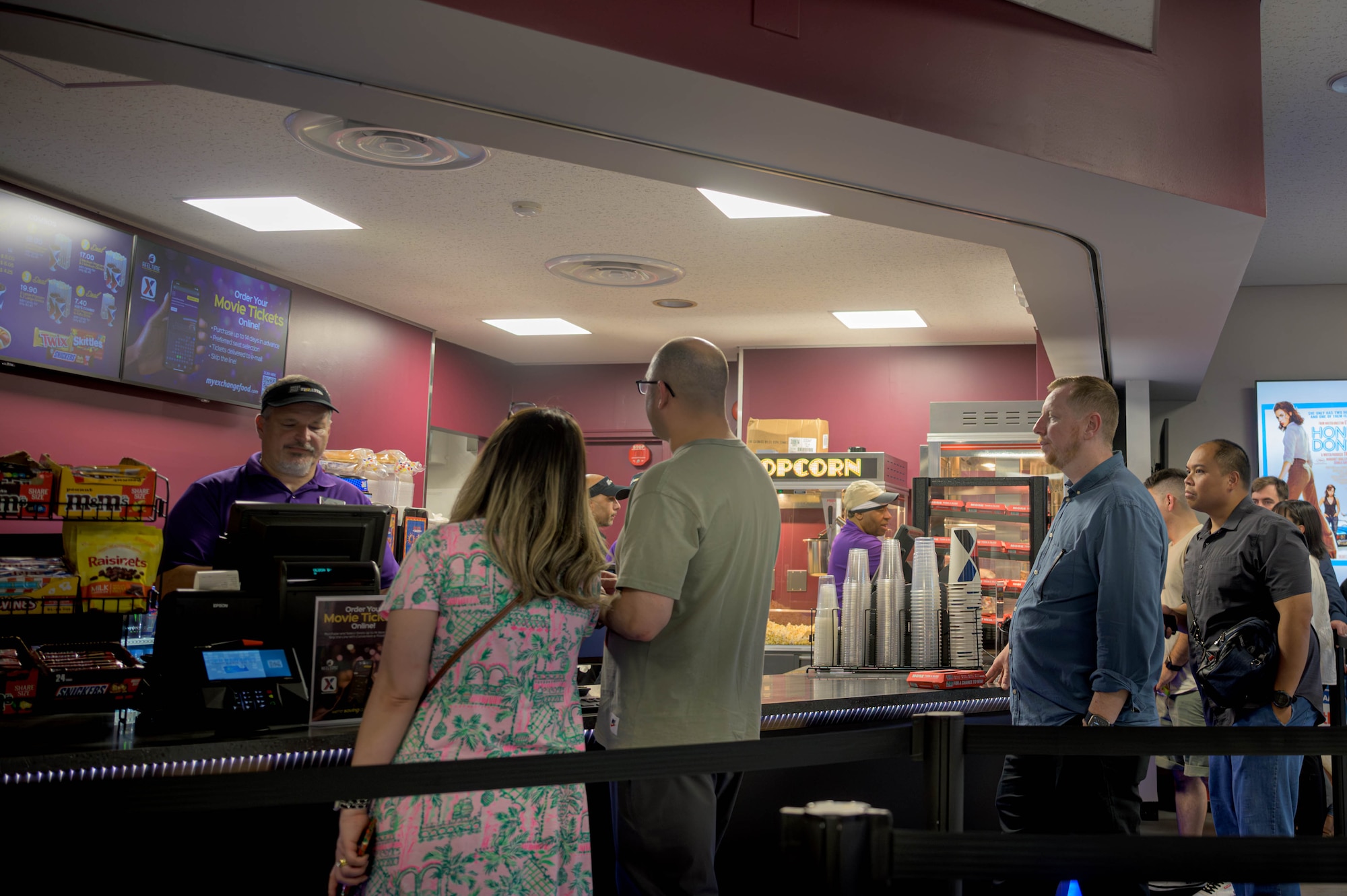 Members of Team Yokota purchase snacks during the grand reopening of the base theater at Yokota Air Base, Japan, July 25, 2025. The theater offers a space that enhances morale, fosters connection, and contributes to the quality of life for Airmen, families, and the broader base community.