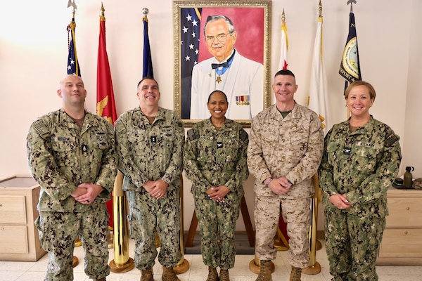TWENTYNINE PALMS, Calif. — Rear Adm. Matthew Case (center-left), Chief of the Navy Medical Service Corps, visits Navy Medicine Readiness and Training Command Twentynine Palms, July 30, 2025. Commanding officer Capt. Janiese Cleckley (center), executive officer Capt. Candace Foura (right), acting command master chief Senior Chief Hospital Corpsman Matthew Ritchie (left), and Marine Corps Air Ground Combat Center commanding general Maj. Gen. Mark Clingan (center-right) get their photo taken with the admiral. The visit marked the 78th birthday of the Medical Service Corps and included facility tours, leadership engagements, and an all-hands MSC officers call highlighting the Corps’ ongoing commitment to medical readiness and support of the warfighter. (U.S. Navy photo by Christopher Jones, NMRTC/NH public affairs officer).