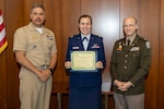 Walter Reed Chief of Staff Chief of Staff, U.S. Navy Capt. Juan Rosario (left) and U.S. Army Lt. Col. (Dr.) Michael Orestes, director for Education, Training and Research at Walter Reed (right) recognize U.S. Air Force Maj. (Dr.) Melissa Meister for her research work at the recent 17th Annual National Capital Region (NCR) Research and Inquiry Competitions recognition program. Meister advanced to the 40th Annual Navy-wide Academic Research Competition, earning first place in the clinical research trainee category.