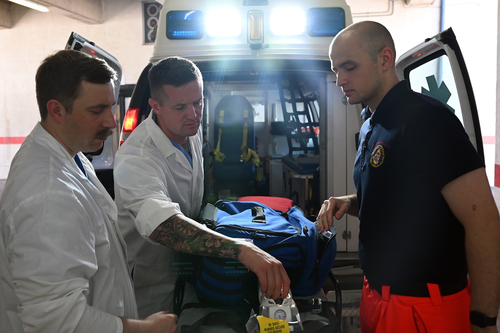 U.S. Air National Guard Technical Sgt. Nathaniel Sechrist, left, U.S. Air National Guard Master Sgt. Dylan Vogel, middle, U.S. Navy Hospital Corpsman 3rd Class Jarret Grant, right, conducts an inventory of an ambulance vehicle on Naval Air Station Sigonella, Sicily, July. 15, 2025.