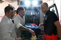 U.S. Air National Guard Technical Sgt. Nathaniel Sechrist, left, U.S. Air National Guard Master Sgt. Dylan Vogel, middle, U.S. Navy Hospital Corpsman 3rd Class Jarret Grant, right, conducts an inventory of an ambulance vehicle on Naval Air Station Sigonella, Sicily, July. 15, 2025.