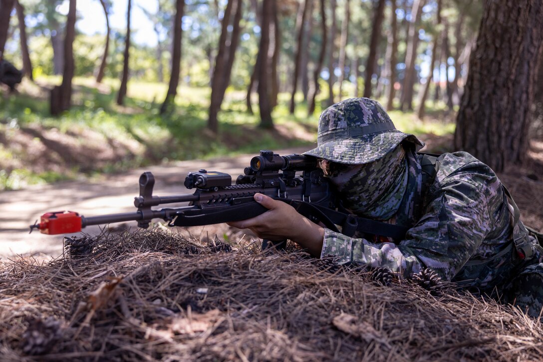 A Republic of Korea Marine with 1st Marine Division, ROK Marine Corps, maintains security during bilateral patrol training as part of the Korean Marine Exercise Program 25.2 in Pohang, South Korea, July 28, 2025. KMEP is conducted regularly between the ROK and U.S. Marine Corps to increase their combined capabilities through realistic training geared towards deterrence and maintaining peace in the Indo-Pacific. (U.S. Marine Corps photo by Cpl. Kanoa Thomas)