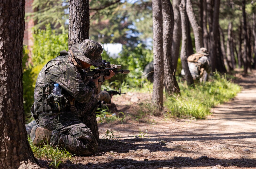 A Republic of Korea Marine with 1st Marine Division, ROK Marine Corps, maintains security during bilateral patrol training as part of the Korean Marine Exercise Program 25.2 in Pohang, South Korea, July 28, 2025. KMEP is conducted regularly between the ROK and U.S. Marine Corps to increase their combined capabilities through realistic training geared towards deterrence and maintaining peace in the Indo-Pacific. (U.S. Marine Corps photo by Cpl. Kanoa Thomas)