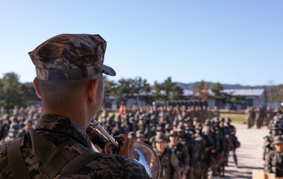 A Republic of Korea Marine with 1st Marine Division, ROK Marine Corps, plays the Marines’ Hymn as part of a formation during the Korean Marine Exercise Program 25.2 in Pohang, South Korea, July 28, 2025. KMEP is conducted regularly between the ROK and U.S. Marine Corps to increase their combined capabilities through realistic training geared towards deterrence and maintaining peace in the Indo-Pacific. (U.S. Marine Corps photo by Cpl. Kanoa Thomas)