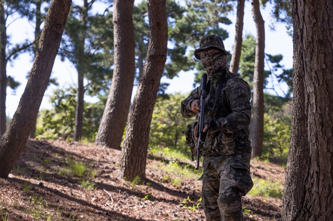A Republic of Korea Marine with 1st Marine Division, ROK Marine Corps, patrols during the Korean Marine Exercise Program 25.2 in Pohang, South Korea, July 28, 2025. KMEP is conducted regularly between the ROK and U.S. Marine Corps to increase their combined capabilities through realistic training geared towards deterrence and maintaining peace in the Indo-Pacific. (U.S. Marine Corps photo by Cpl. Kanoa Thomas)