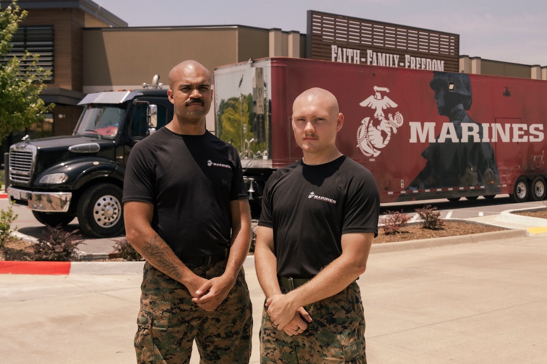 U.S. Marine Corps Sgt. Desmond Taylor Jr., left, and Sgt. Brad Tischer, right, both Enhanced Marketing Vehicle (EMV) Marines with 9th Marine Corps District, pose for a photo in Tulsa, Oklahoma, July 18, 2025. The EMV team is made up of two Marines who travel throughout the district, using the EMV to engage with local communities and support recruiting efforts at public events. (U.S. Marine Corps photo by Staff Sgt. Lennon Dregoiw)
