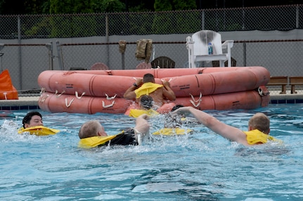 Pilots and boom operators assigned to the 106th and 99th Air Refueling Squadrons swim for their rescue raft during water survival training in Trussville, Ala., August 2, 2025.