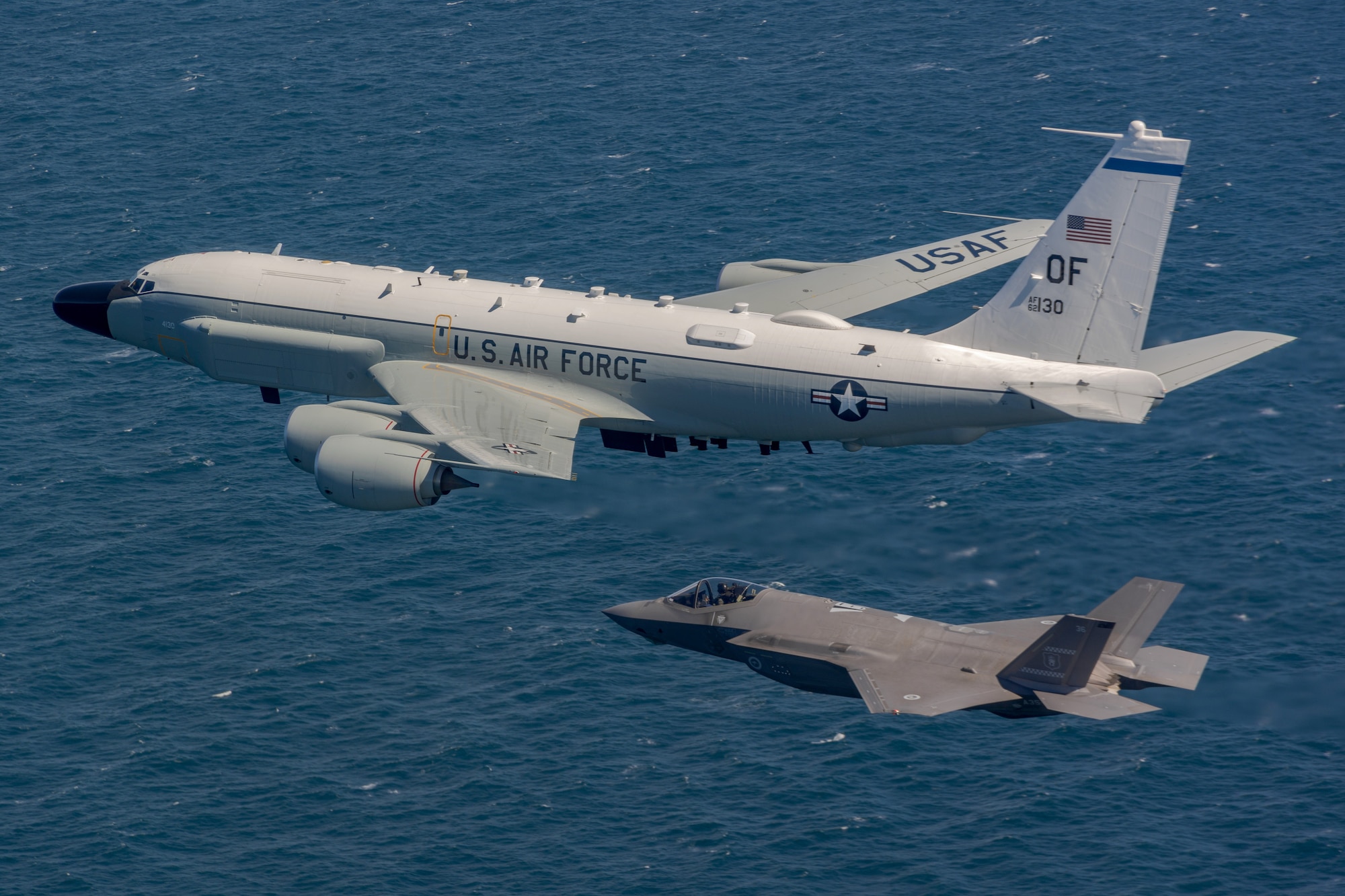 A Royal Australian Air Force F-35A Lightning II flying alongside a United States Air Force RC-135W