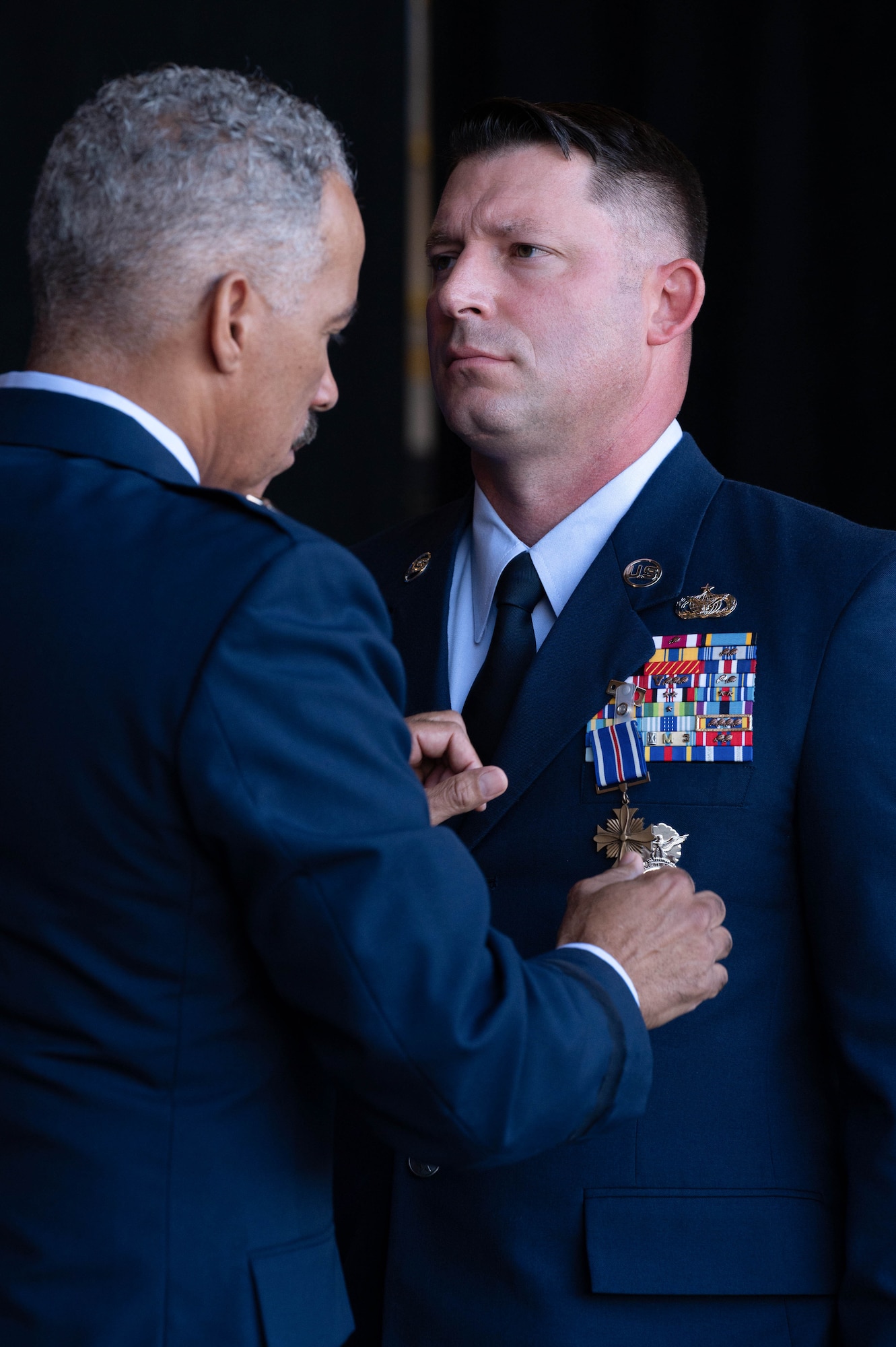 U.S. Air National Guard Brig. Gen. David Cochran, Assistant Adjutant General, pins the Distinguished Flying Cross “DFC” with “C” Device on Master Sgt. Keith McGraw, Phoenix Raven, assigned to the 130th Airlift Wing, Charleston, West Virginia, Aug. 3, 2025. McGraw was awarded the DFC for his distinctive heroism and extraordinary achievement while participating in aerial flight on August 30, 2021 in and over Kabul, Afghanistan in support of Operation Allies Refuge. Operation Allies Refuge was the largest non-combatant evacuation operation in American history where more than 120,000 Afghan citizens were assisted by Airmen. (U.S. Air National Guard photo by Staff Sgt. Alancea Grant)