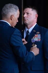 U.S. Air National Guard Brig. Gen. David Cochran, Assistant Adjutant General, pins the Distinguished Flying Cross “DFC” with “C” Device on Master Sgt. Keith McGraw, Phoenix Raven, assigned to the 130th Airlift Wing, Charleston, West Virginia, Aug. 3, 2025. McGraw was awarded the DFC for his distinctive heroism and extraordinary achievement while participating in aerial flight on August 30, 2021 in and over Kabul, Afghanistan in support of Operation Allies Refuge. Operation Allies Refuge was the largest non-combatant evacuation operation in American history where more than 120,000 Afghan citizens were assisted by Airmen. (U.S. Air National Guard photo by Staff Sgt. Alancea Grant)