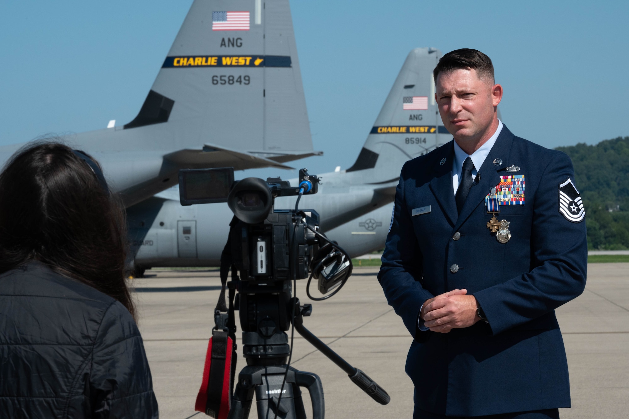 U.S. Air National Guard Master Sgt. Keith McGraw, Phoenix Raven,  conducts an interview with WOWK13 news reporter at the 130th Airlift Wing, Charleston, West Virginia, Aug. 3, 2025. McGraw received the Distinguished Flying Cross Medal with “C” device for his distinctive heroism and extraordinary achievement while participating in aerial flight on August 30, 2021 in and over Kabul, Afghanistan in support of Operation Allies Refuge. Operation Allies Refuge was the largest non-combatant evacuation operation in American history where more than 120,000 Afghan citizens were assisted by Airmen. (U.S. Air National Guard photo by Staff Sgt. Alancea Grant)