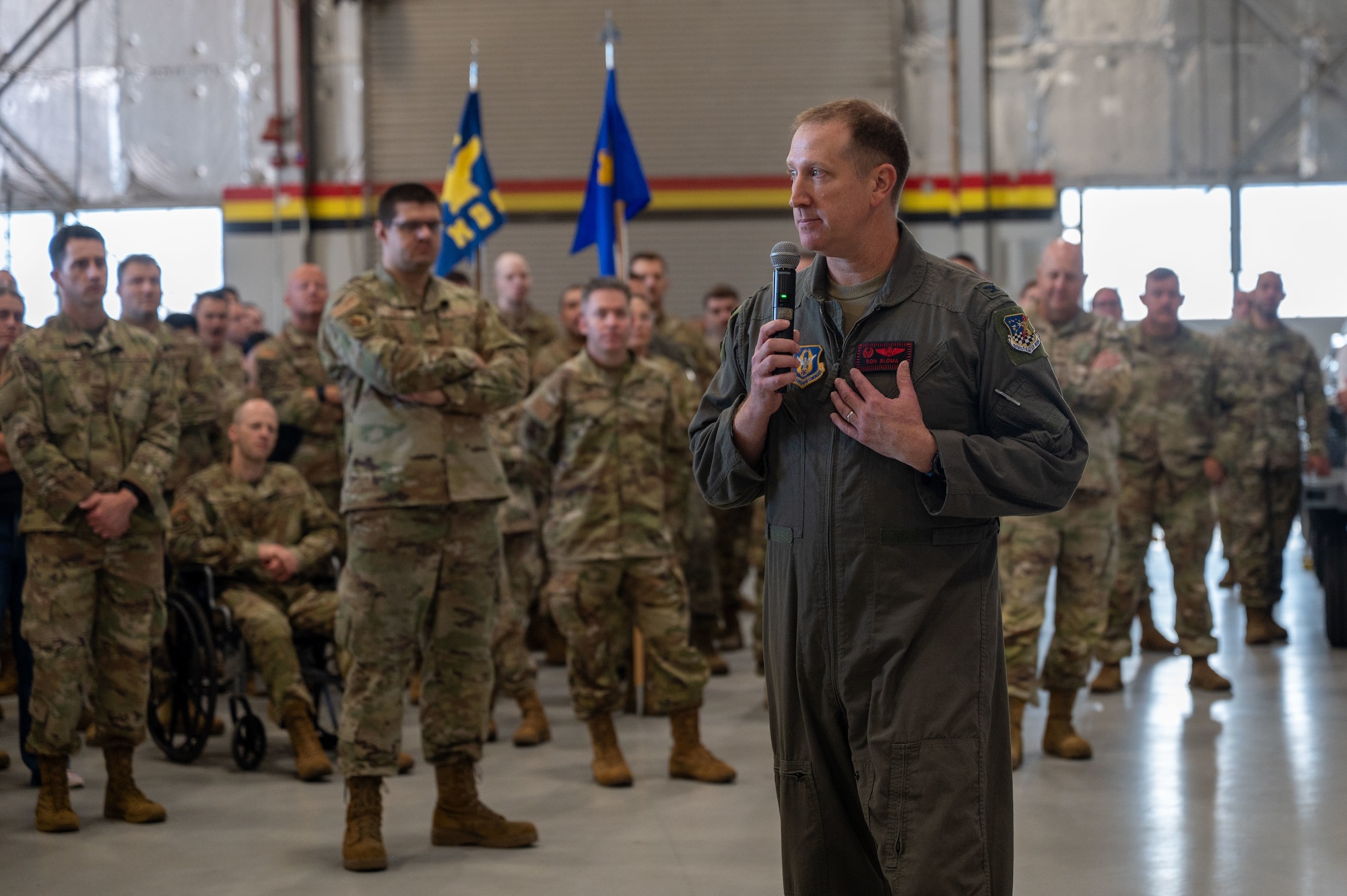 Wing Commander speaks to a group of Airmen