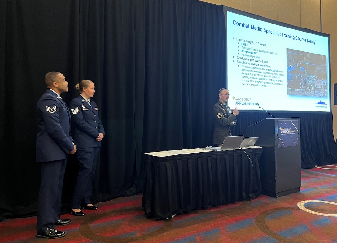 Army Sgt. 1st Class Devin Bigelow, an instructor for the Combat Medic Specialist Training Course (CMSTC) at the Medical Education and Training Campus on Joint Base San Antonio-Fort Sam Houston, Texas, delivers a presentation about the CMSTC at the American Medical Technologists Annual Meeting in Pittsburgh, Pa. July 23 while fellow METC instructors, Air Force Tech. Sgt. Jessica McCleary and Air Force Staff Sgt. Jheryl Stuckey, look on.