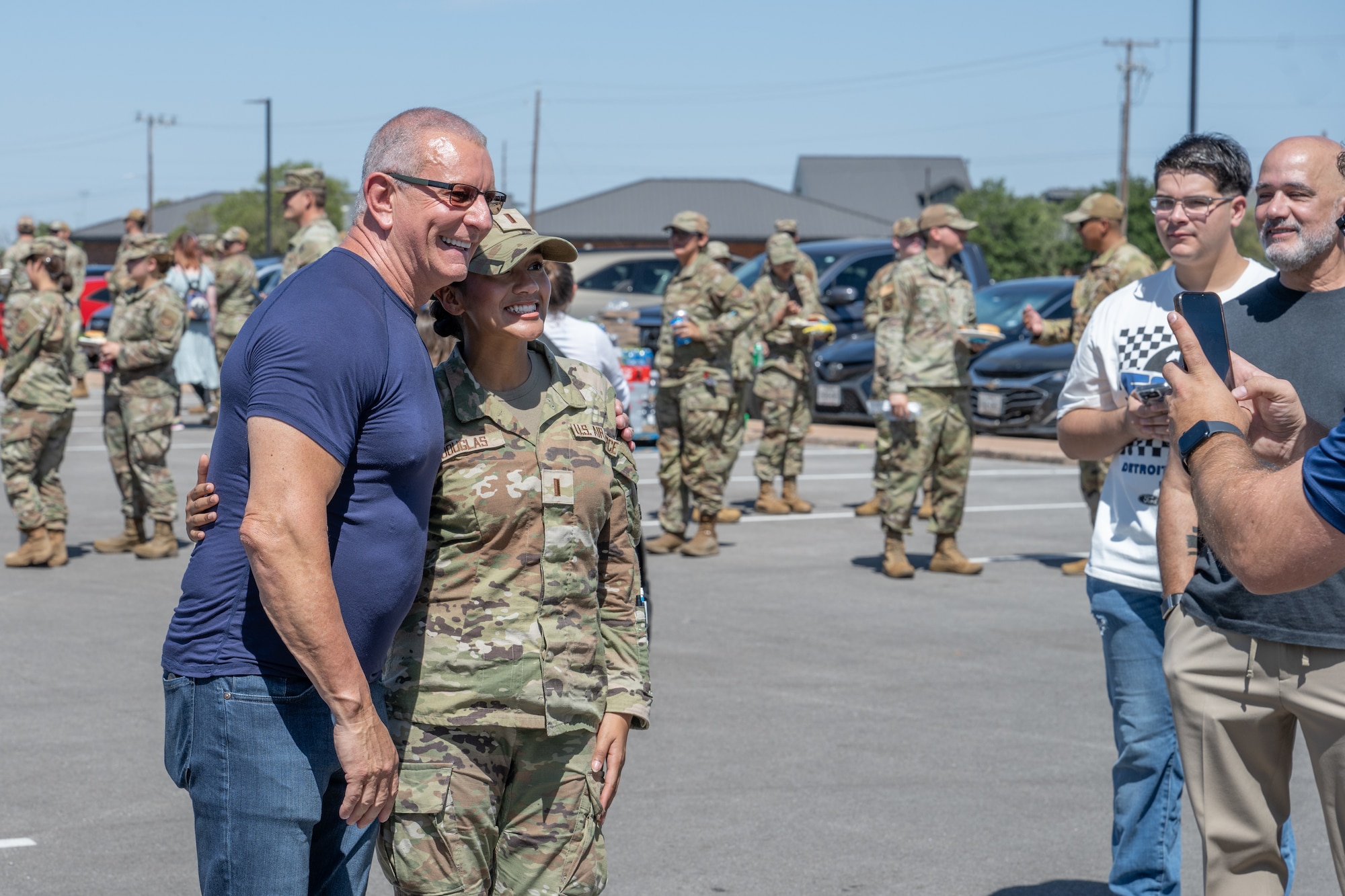 Celebrity Chef Robert Irvine takes a photo with U.S. Air Force 2nd Lt Nevaeh Douglas, 317th Aircraft Maintenance Squadron officer, during the “Breaking Bread with Heroes” event at Dyess Air Force Base, Texas, July 31, 2025. A veteran of the Royal Navy, Irvine regularly visits military installations, hosts morale-boosting events, and advocates for greater public awareness of the challenges faced by service members. (U.S. Air Force photo by Airman Caleb Schellenberg)