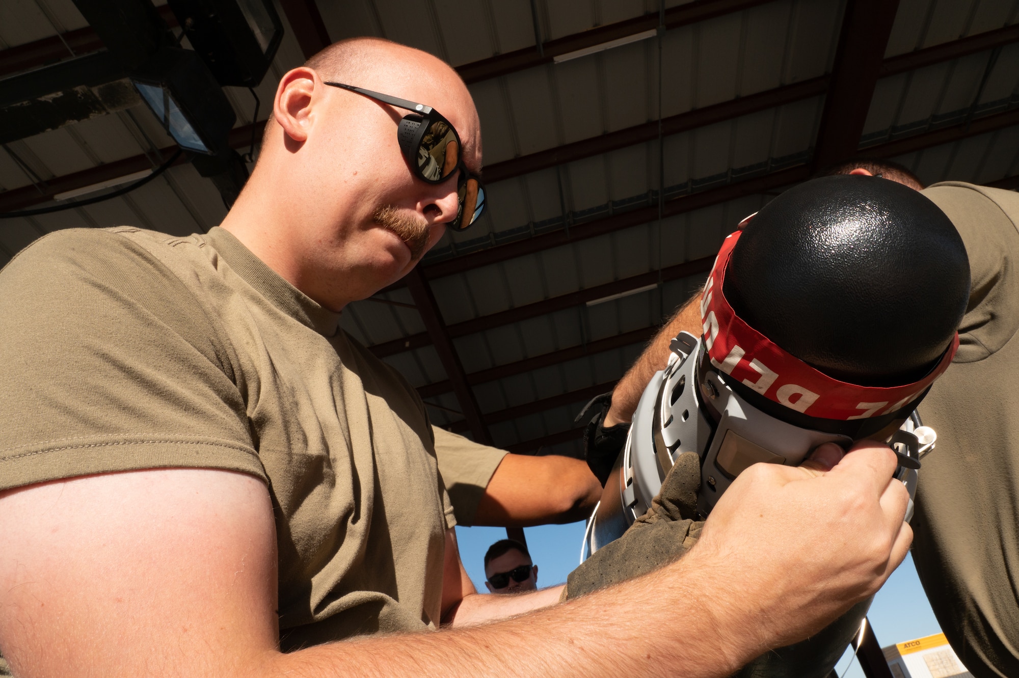 A photo of munitions Airmen building a GBU-56