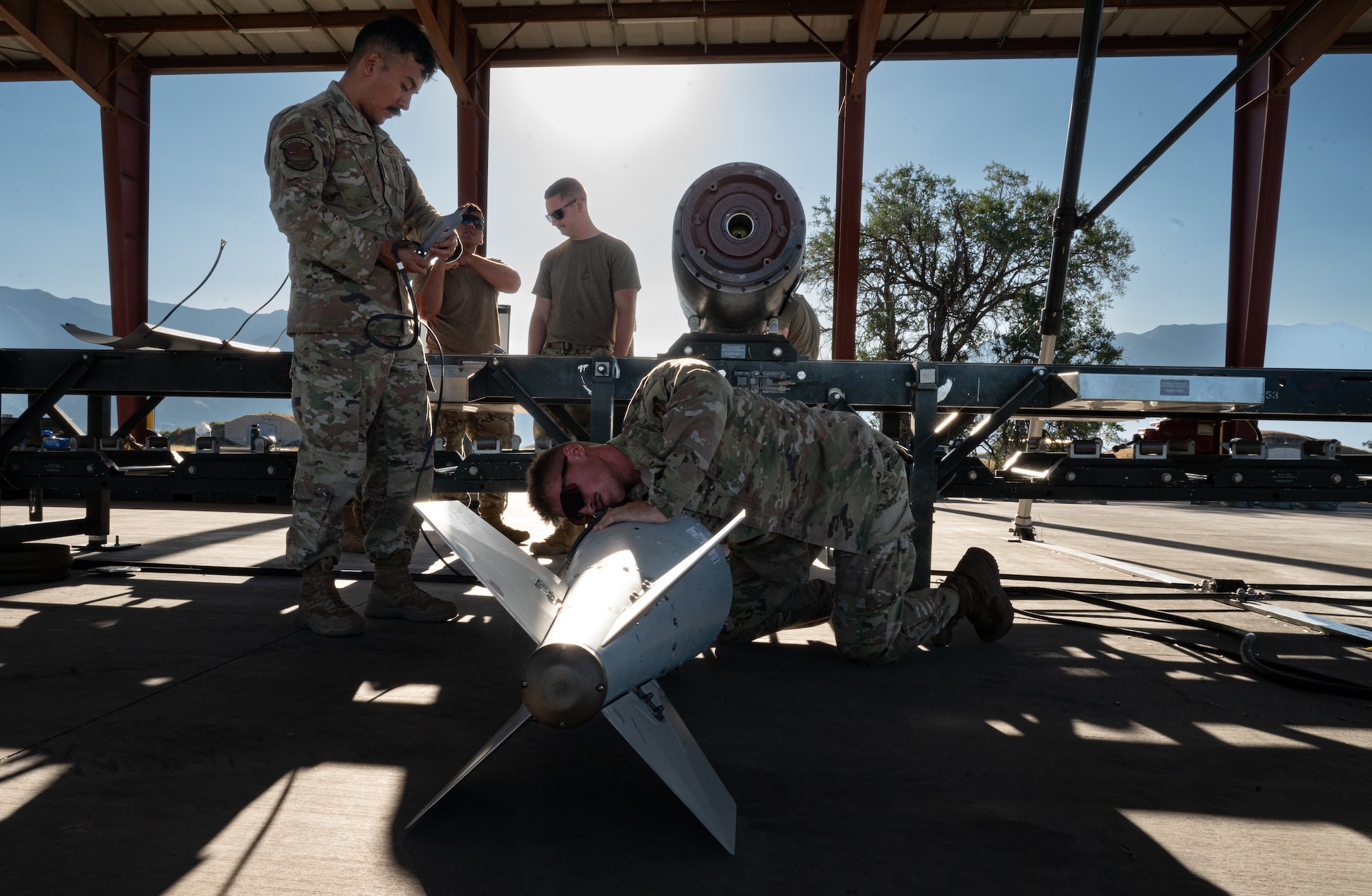 A photo of munitions Airmen building a GBU-56