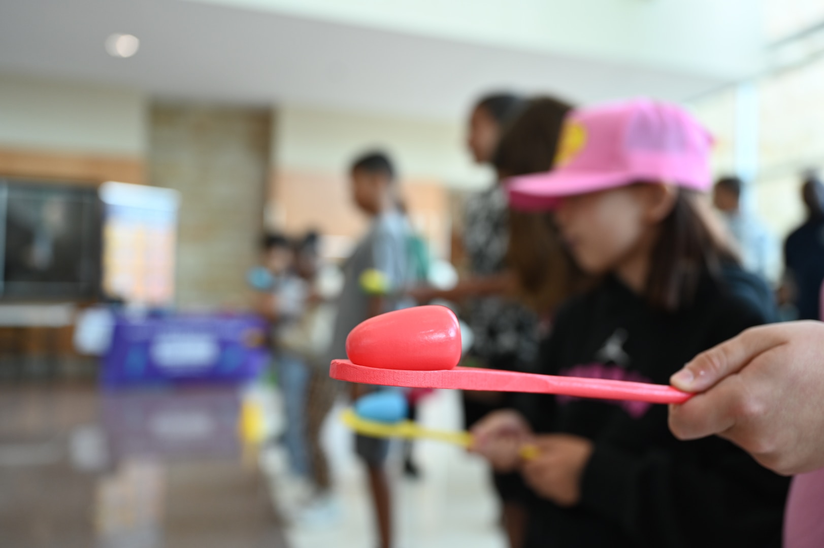 Children take part in an egg race during Kidz Fest at Carl R. Darnall Army Medical Center, Aug. 2. The event also featured a sack race, face painting, a backpack raffle, and other family-friendly activities.