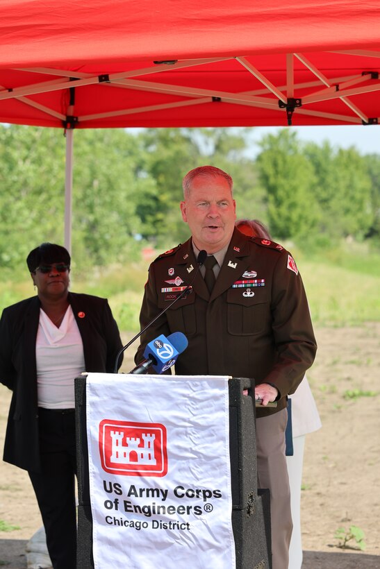 Commander stands behind podium during ceremony to give remarks.