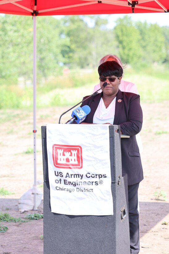 Women stands behind U.S. Army Corps of Engineers podium to give remarks.