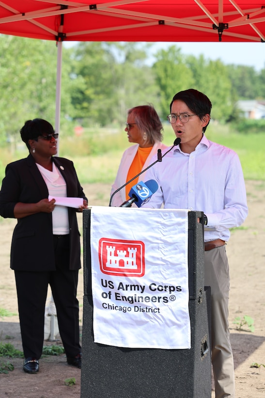Man stands behind a U.S. Army Corps of Engineer podium to give remarks.