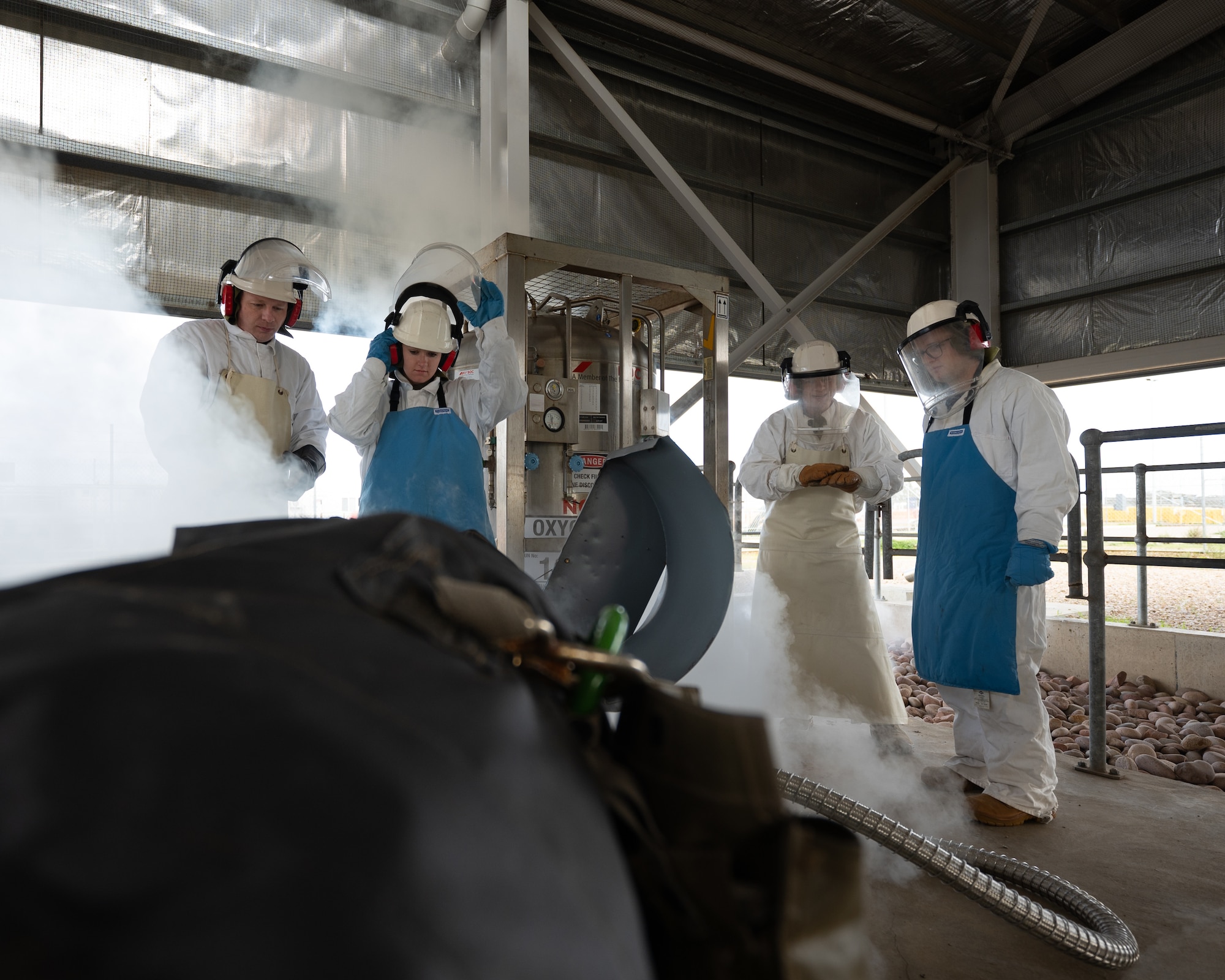 USAF and RAAF members fill up two liquid oxygen tanks