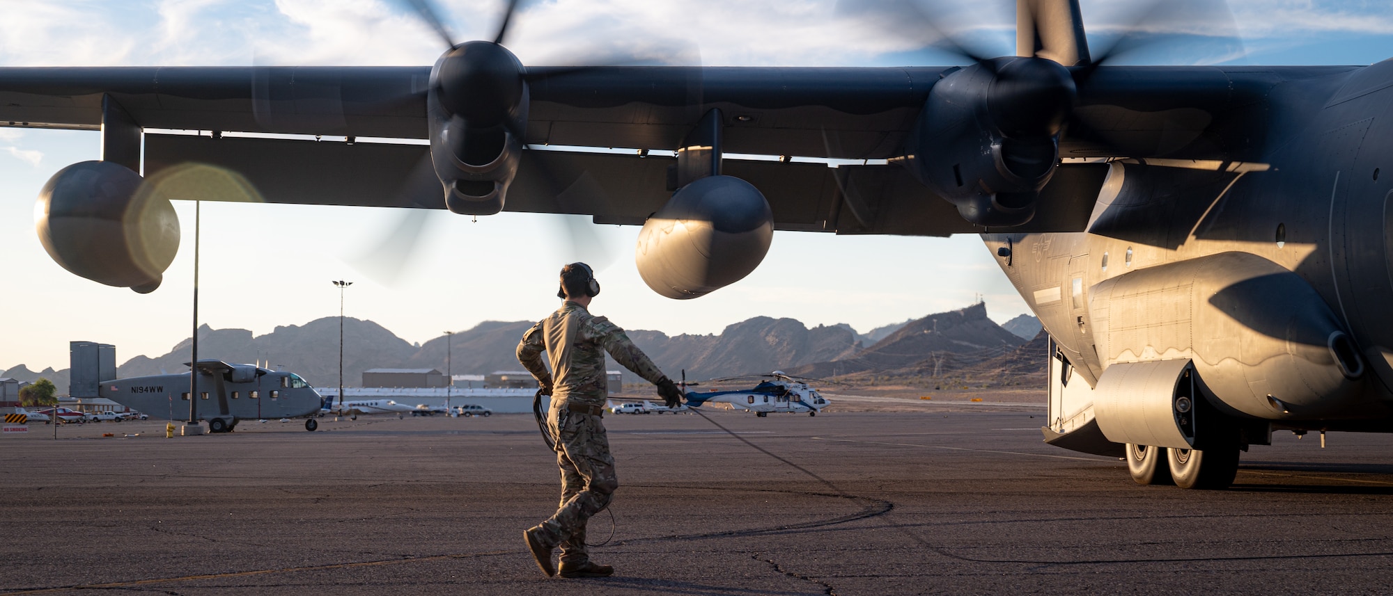 A U.S. Air Force Air Commando assigned to AFSOC conducts engine startup checks on a MC-130J Commando II aircraft during Emerald Warrior 25.2.