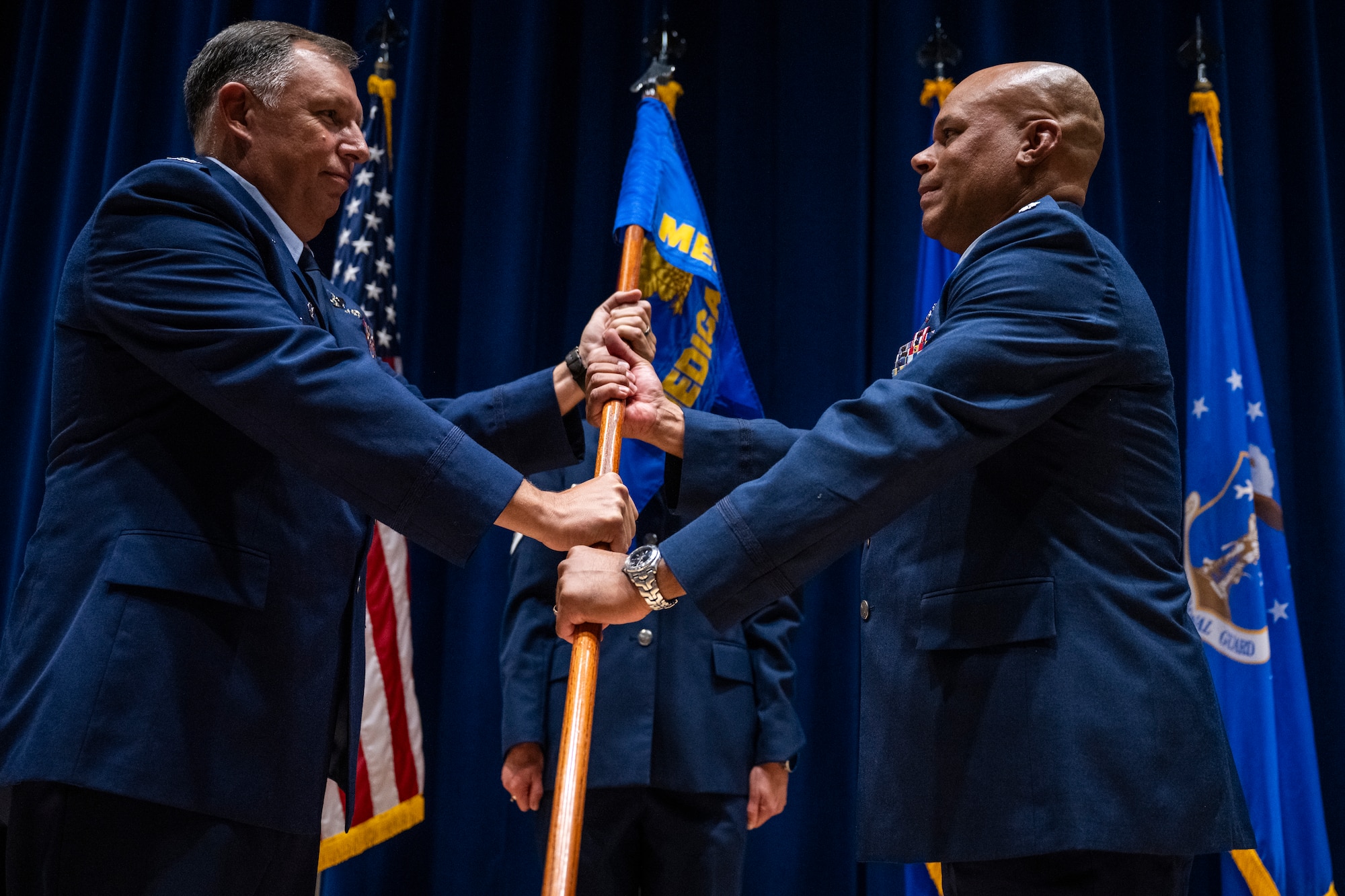 U.S. Air National Guard Colonel Jaison Brown, Commander of the 134th MDG, right, accepts the guidon from Col. Ron Selvidge, commander of the 134th Air Refueling Wing, during a change of command ceremony at McGhee Tyson Air National Guard Base, Louisville, Tenn., on August 2, 2025.