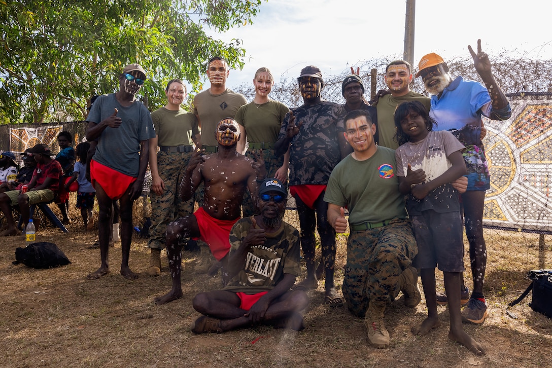 U.S. Marines with Marine Rotational Force – Darwin 25.3 pose for a group photo with Tiwi Islands locals during the Tiwi Culture Festival, in the Tiwi Islands, Australia, July 19, 2025. Marines took part in the Tiwi Culture Festival in order to support the community, participate in cultural activities, and learn more about the Tiwi people’s traditions. MRF-D is an annual six-month rotational deployment to enhance interoperability with the Australian Defence Force and allies and partners and provide a forward postured crisis response force in the Indo-Pacific. (U.S. Marine Corps photo by Cpl. Keegan Jones)