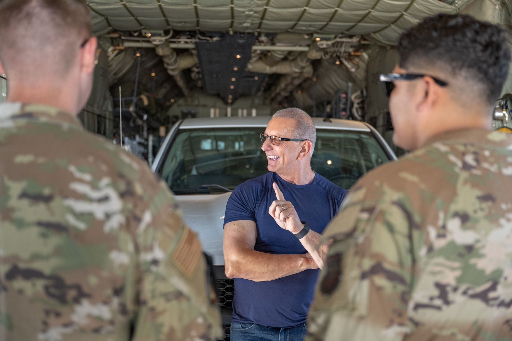 Celebrity Chef Robert Irvine receives a briefing from crew chiefs assigned to the 317th Aircraft Maintenance Squadron aboard a C-130J Super Hercules at Dyess Air Force Base, Texas, July 31, 2025. Drawing on his military background, Irvine uses his platform to promote physical and mental wellness, combat readiness, and long-term stability for service members. (U.S. Air Force photo by Airman Caleb Schellenberg)