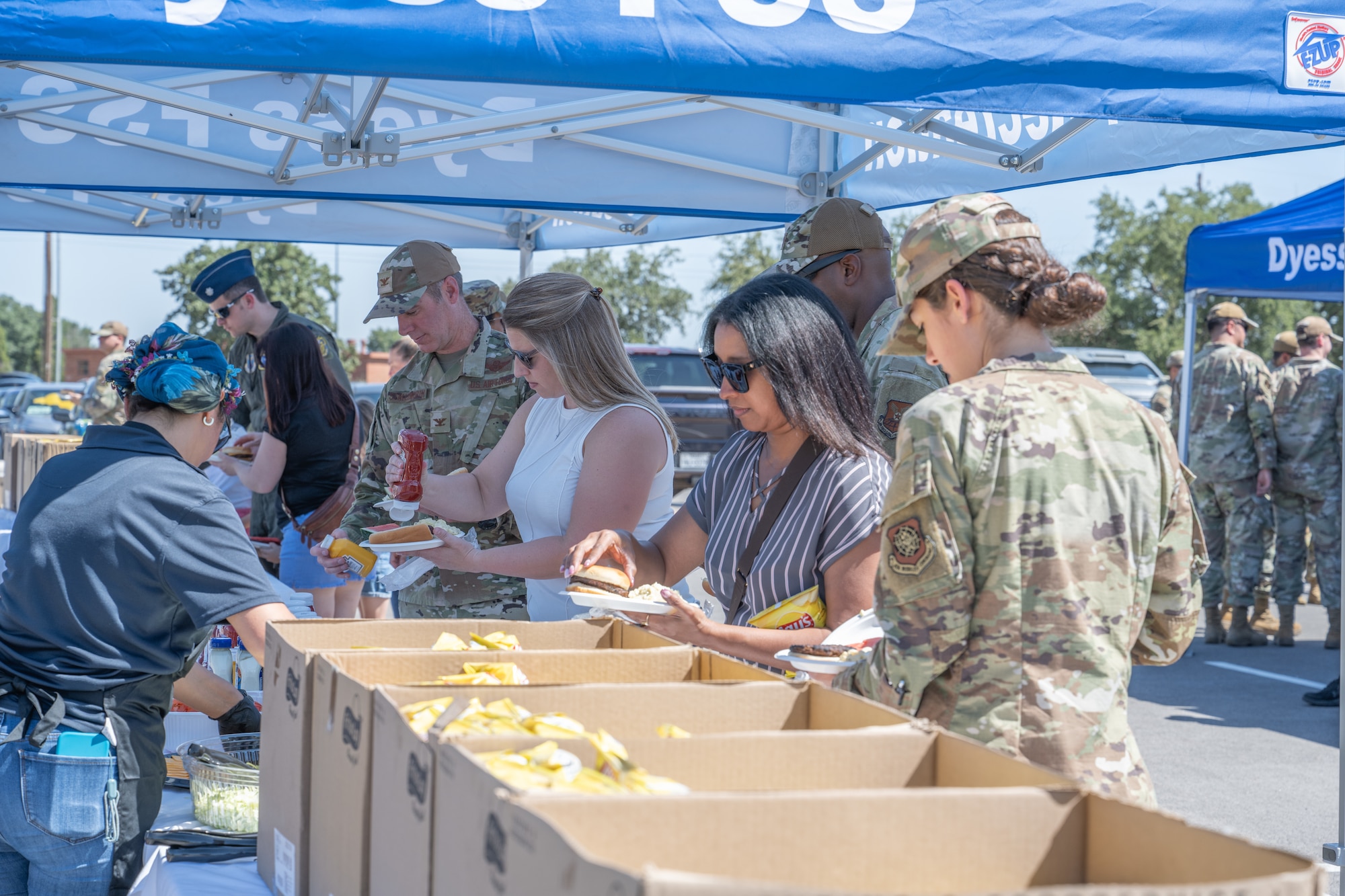 Team Dyess members receive food during the “Breaking Bread with Heroes” event at Dyess Air Force Base, Texas, July 31, 2025. The event was part of the Robert Irvine Foundation’s "Breaking Bread with Heroes" program, which aims to enhance the quality of life for service members through health, fitness, and resiliency initiatives. (U.S. Air Force photo by Airman Caleb Schellenberg)