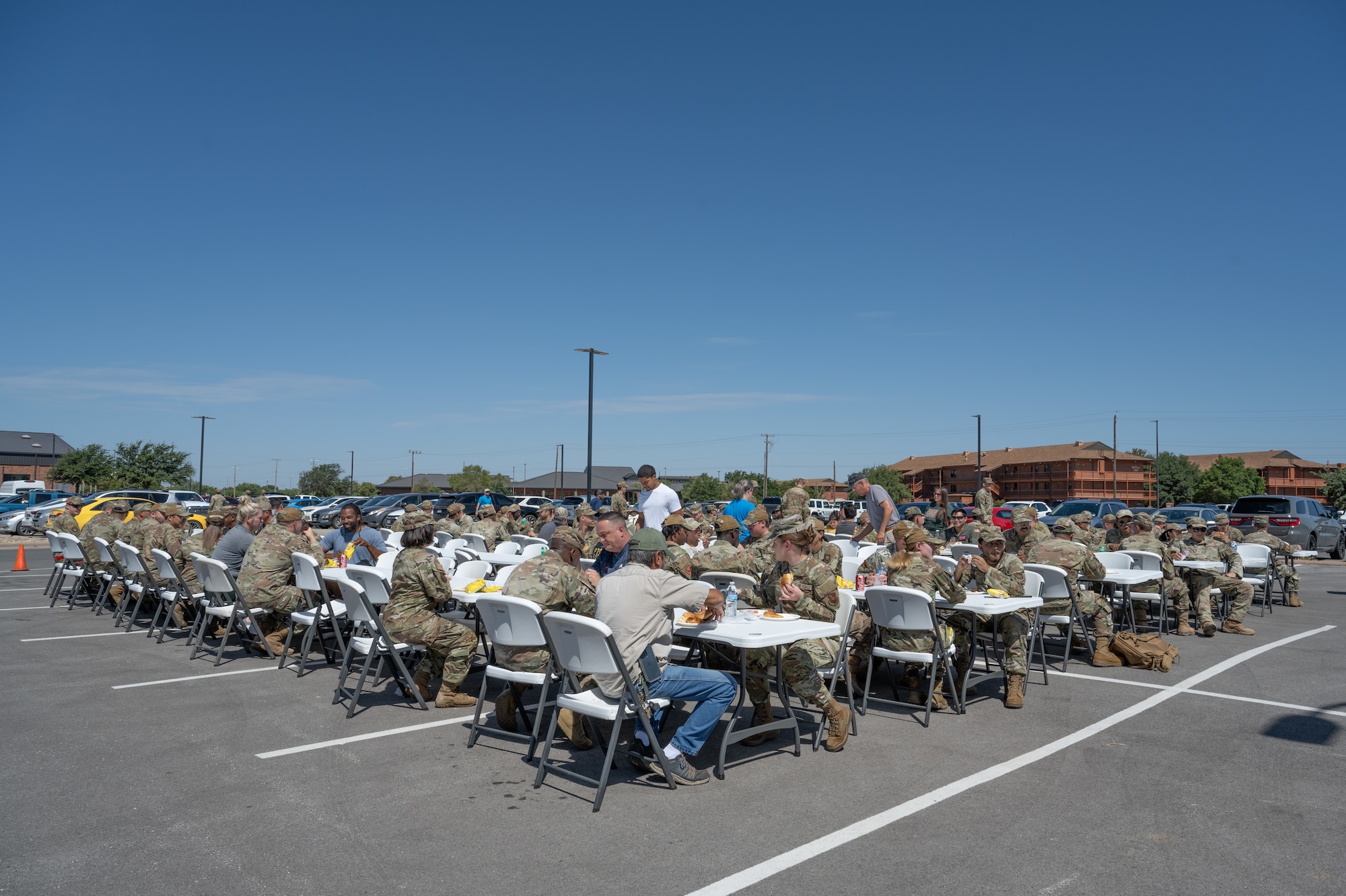 Team Dyess members share a meal during the “Breaking Bread with Heroes” event at Dyess Air Force Base, Texas, July 31, 2025. As part of the event, Celebrity Chef Robert Irvine and his foundation provided more than 1,200 meals for Dyess personnel and their families. (U.S. Air Force photo by Airman Caleb Schellenberg)