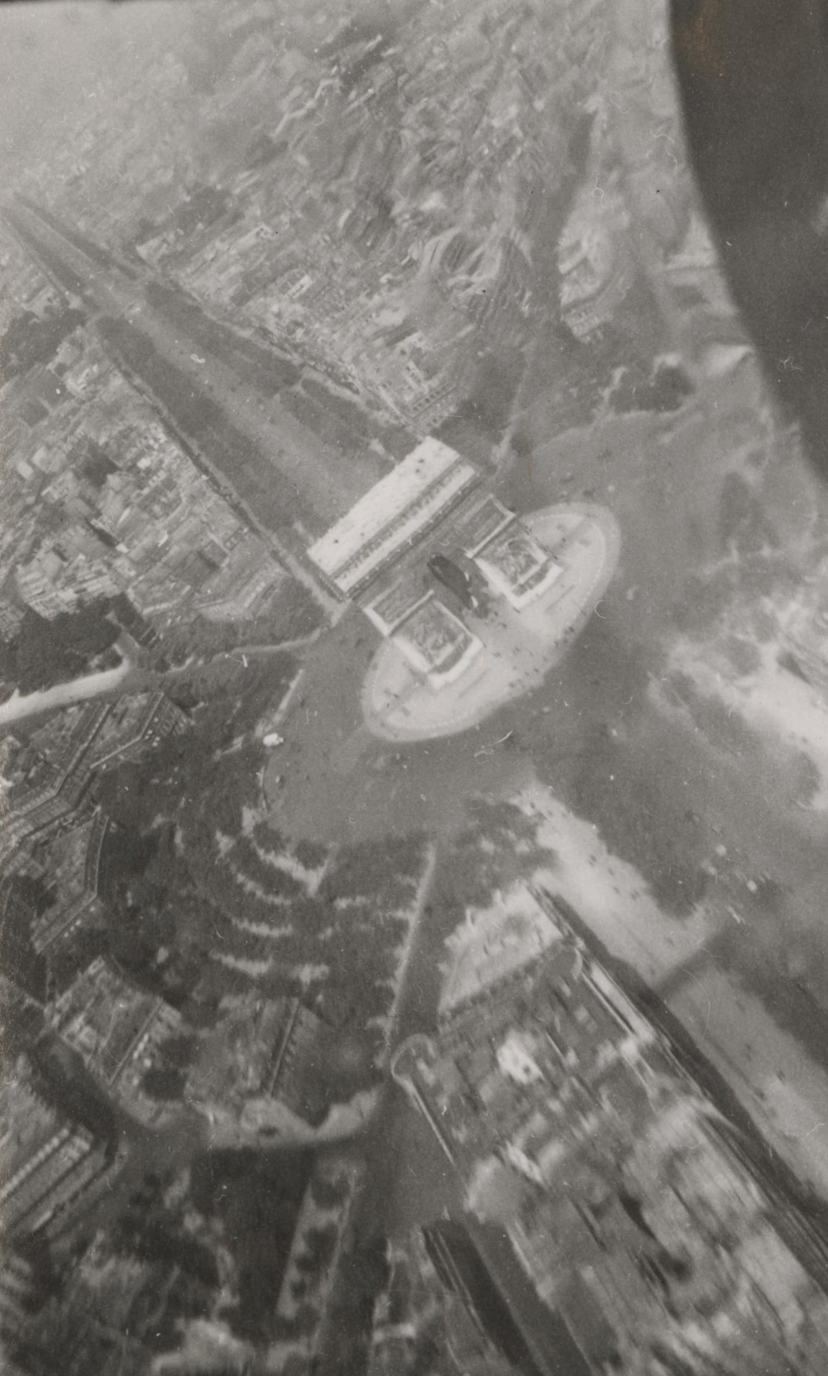 Black and white photo from 1945 of Lieutenant John Flory flying over the Arc de Triomphe in Paris France.